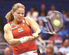 Kim Clijsters of Belgium returns a backhand to Venus Williams of the USA 