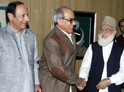 Islamic alliance vice-president Qazi Hussain Ahmed(R) greets National Alliance leader Farooq Ahmed Khan Leghari(C) as Chaudhry Shujaat Hussain of the pro-military Pakistan Muslim League looks on 