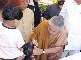 Chief Minister Sheila Dikshit administers polio drops to a child at her residence.