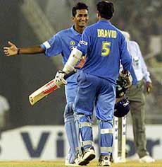 India's Sanjay Bangar (L) and teammate Rahul Dravid celebrate after winning 