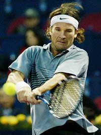 Carlos Moya of Spain returns a shot