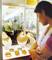 A girl has a look at ornaments displayed at Swaran Sambandh, a jewellery exhibition
