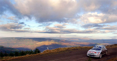 Finland's Harri Rovanpera and co-driver Risto Pietilainen drive through the Welsh mountains