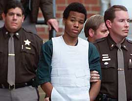 Washington area sniper suspect John Lee Malvo is escorted out of the Fairfax county juvenile court in Virginia on Friday. He was at a hearing to decide whether he be tried as an adult or a minor