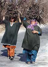 Two Kashmiri village women return to their home