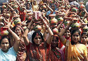Women carry earthen water pots