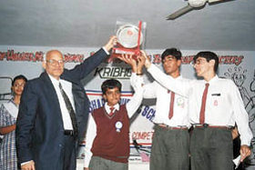 Vishwa Bharti Public School debate team receiving the trophy.