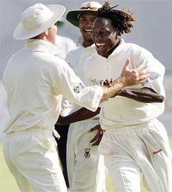Zimbabwe bowler Henry Olonga celebrates the dismissal of Pakistan batsman Hassan Raza
