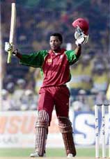 Chris Gayle of the West Indies acknowledges his century during the fifth one-day international between India and the West Indies in Baroda on Monday