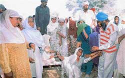 Tej Kaur, whose family was dependent on the piece of panchayat land, faints 