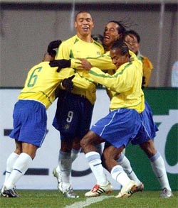 Brazil's national team player Ronaldo is hugged by his teammates 