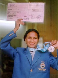 Madhuri A. Singh shows the cheque