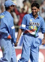 Indian bowler Ajit Agarkar celebrates the dismissal of West Indies batsman Shivnarine Chanderpaul with the teammate Mohammad Kaif