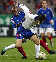 Sylvain Wiltord of France challenges Goran Trobok of Yugoslavia