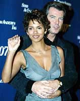 Pierce Brosnan (R) who plays James Bond embraces his co-star
