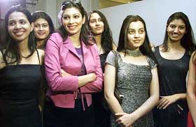 Former Miss World Yukta Mookhey stands besides model contestants