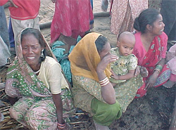 Jhuggi dwellers wail outside their hutments