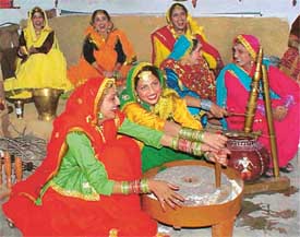 Students of the Government College for Women create a village scene