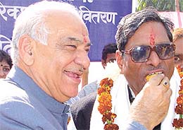 Delhi BJP president Madan Lal Khurana offering sweets to East Delhi MP Lal Bihari Tiwari on the latter�s 61st birthday at his residence in the Capital on Saturday