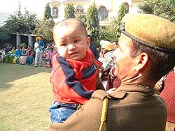 A CRPF jawan holds a test-tube baby