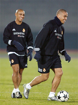 European champion Spain's Real Madrid striker Ronaldo of Brazil smiles with compatriot Roberto Carlos