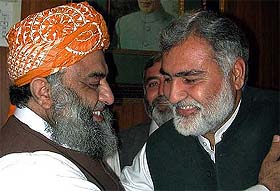 Akram Durrani of the MMA is greeted by his party leader 