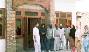 Villagers discuss the issue concerning a piece of land at Jaspal Bangar village