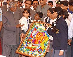 Coast Guard Public School students present a memento painted as Shakti to President A.P.J. Abdul Kalam