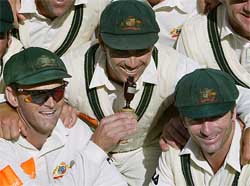 Australian team members Adam Gilchrist , Damien Martyn and captain Steve Waugh pose for a team photo