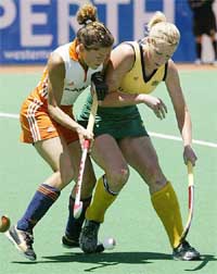 Australia's Sarah Taylor battles for the ball with Macha van der Vaart of the Netherlands