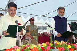 Governor of North-West Frontier Province Syed Iftikhar Hussain Shah administers oath to Chief Minister of the province Muhammad Akram Durrani as Prime Minister Mir Zafarullah Khan Jamali sits 