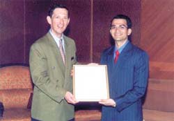 Gautam Dadlani receiving award from Hans Georg Rohrbein
