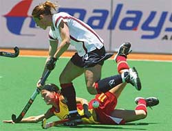 England's Rachel Walker clashes with Spain's Mar Feito during their Women's World Cup hockey