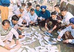 Subscribers collect their telephone bills scattered in front of a post office at Lalru on Thursday