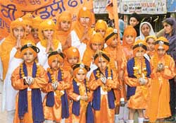 Children, dressed in traditional Khalsa robes, accompany a nagar kirtan