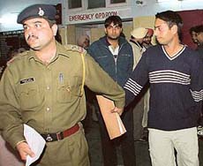 Sanjeev, son of DSP Om Prakash, who was arrested on an attempt to murder charge, being brought from the hospital after a medical examination in Chandigarh on Sunday.