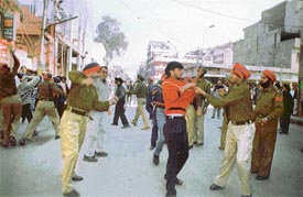 Policemen beat up some persons during a confrontation with shopkeepers of the Calibre Plaza AC market