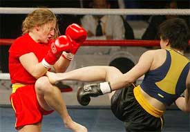 China's He Wei (R) kicks Hungary's Mandor Balaogh 