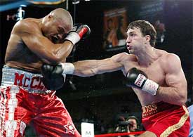 Jameel McCline (L) of Port Jefferson, New York is hit with a body shot by WBO heavyweight champion Wladimir Klitschko