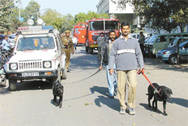 Cops with sniffer dogs at Bahadur Shah Zafar Marg after the hoax bomb call