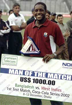 Jermaine Lawson smiles with the Man of the Match award after defeating Bangladesh 