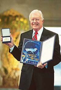 Former U.S. President Jimmy Carter shows his Nobel Peace Prize he received at a ceremony in Oslo City Hall on Tuesday.