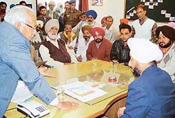 Additional Deputy Commissioner UT Inderjit Singh Sandhu listens to the grievances of villagers at Kajheri village