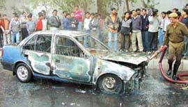 A fireman in action after the car of a doctor caught fire suddenly on DDU Marg in the Capital on Wednesday.