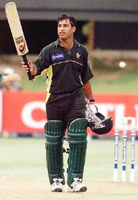 Pakistani batsman Salim Elahi raises his bat after completing a century