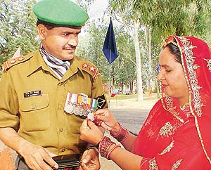Wife of Naib Subedar M.S. Shekhawat admires the Sena Medal awarded to him, at 