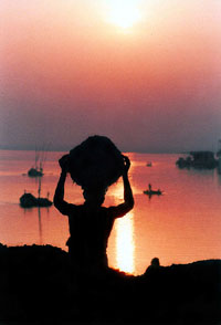 A labourer carries sand on his basket