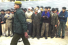 Kashmiri pedestrians and shopkeepers being rounded up after a grenade attack
