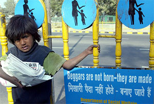 A child, working part-time as newspaper seller, waits for customers