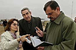 A member of the United Nations arms inspection team talks to Iraqi officials before a search for weapons of mass destruction in Baghdad